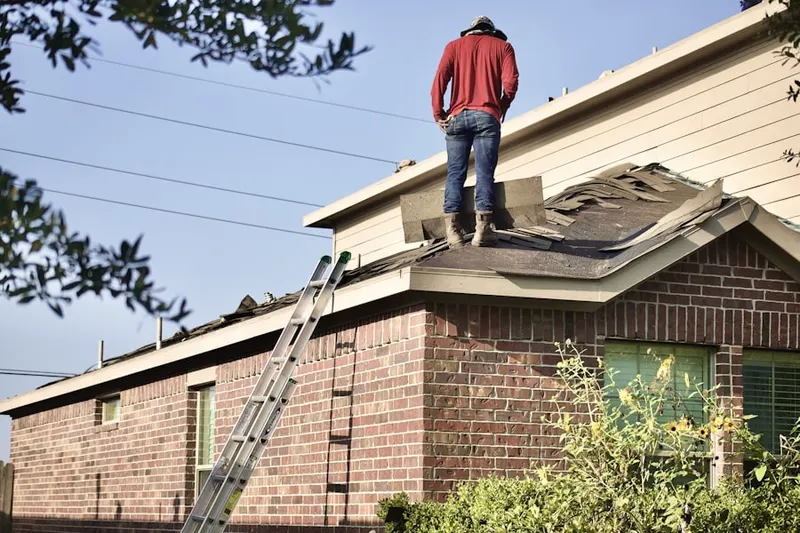 Professional roofer working on a residential roof in Panorama Village